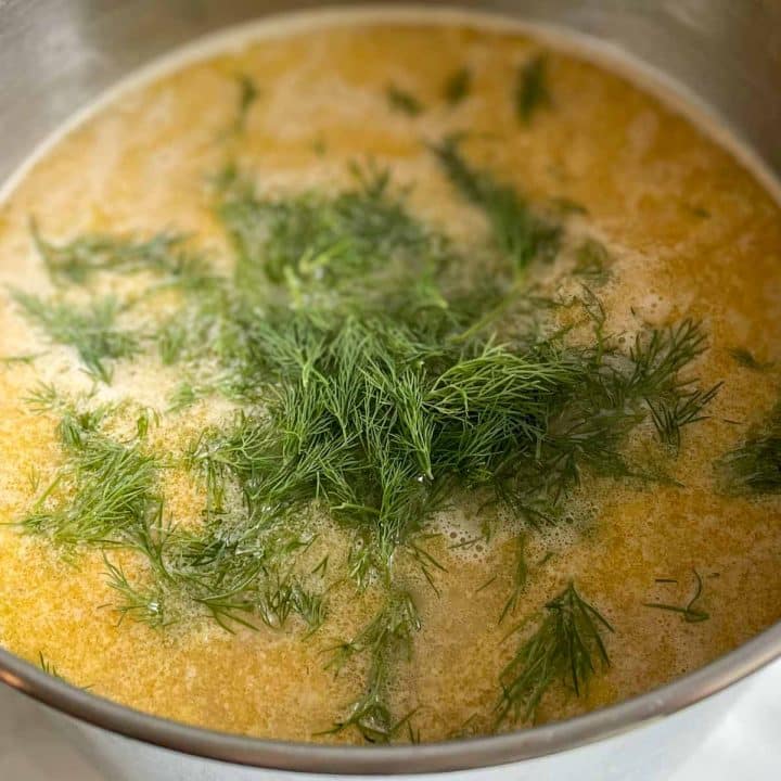 Fresh dill is added to a pot of Greek Chickpea Soup.