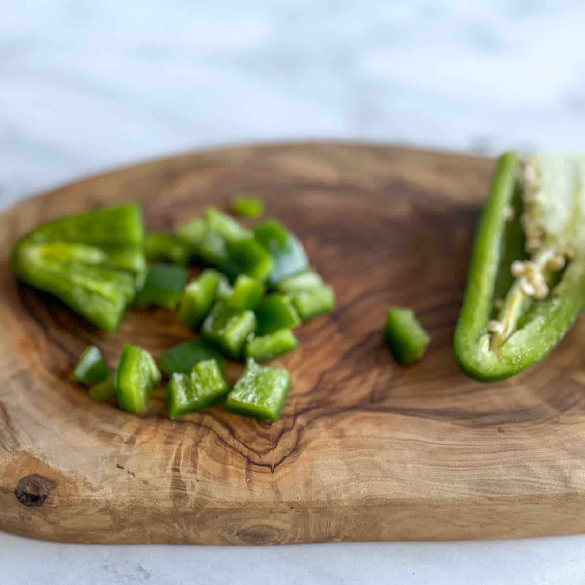 The sliced jalapeno has been cut widthwise to create a small dice.