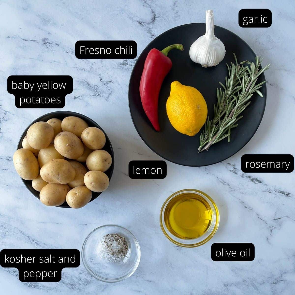 Overhead shot showing labeled ingredients: potatoes, salt, pepper, olive oil, rosemary, garlic, lemon, and fresno chili.