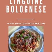 Plate of linguine bolognese with recipe title and URL for Two Cloves Kitchen displayed.