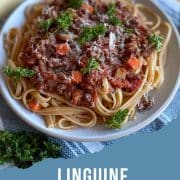 Pinterest image with plate of linguine bolognese, title of dish, and URL for Two Cloves Kitchen.