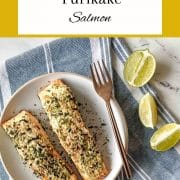 Two baked salmon fillets brushed with mayonnaise and sprinlked with furikake sit on a white plate with the words Furikake Salmon and the URL www.twocloveskitchen.com.
