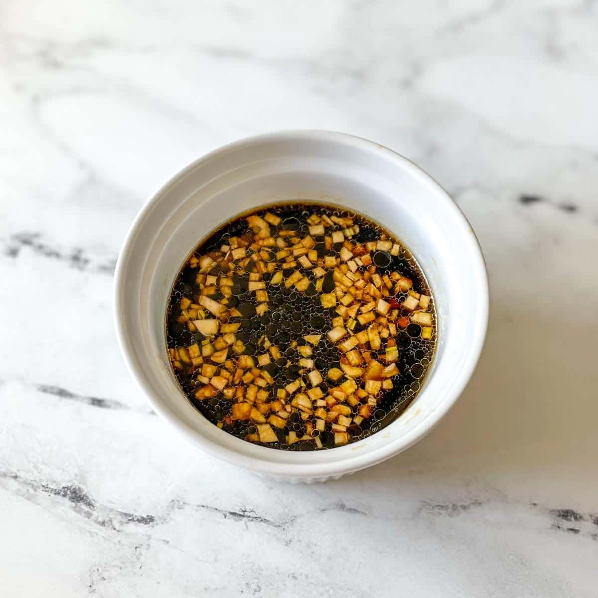 The marinade is shown in a white bowl.