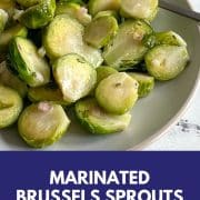 This Pinterest pin shows marinated brussels sprouts in a white bowl with the words marinated brussels sprouts and the URL www.twocloveskitchen.com.