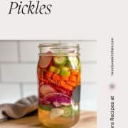 Pinterest pin showing a Mason jar filled with mixed pickles with the title Mixed Pickles and the URL www.twocloveskitchen.com.