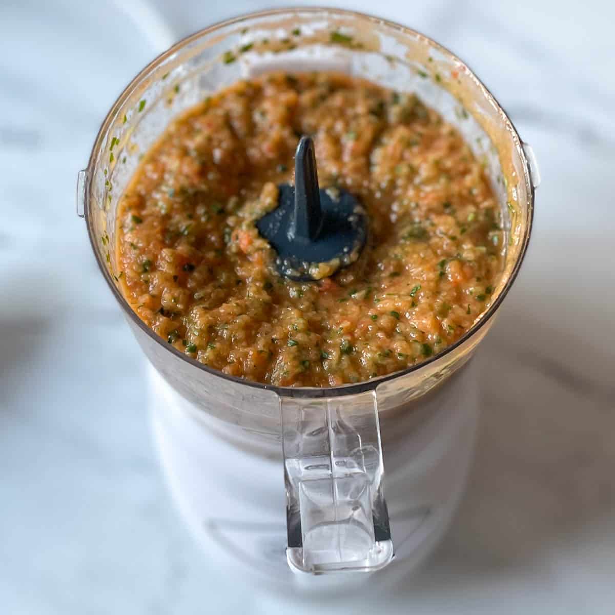 The finished, blended salsa is shown in a mini food processor.