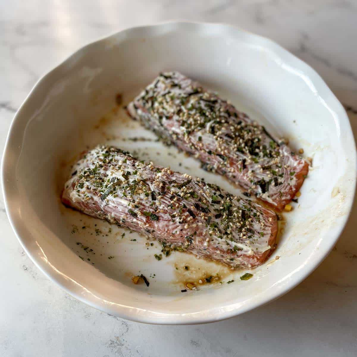 Salmon fillets are brushed with mayonnaise and sprinkled with furikake.