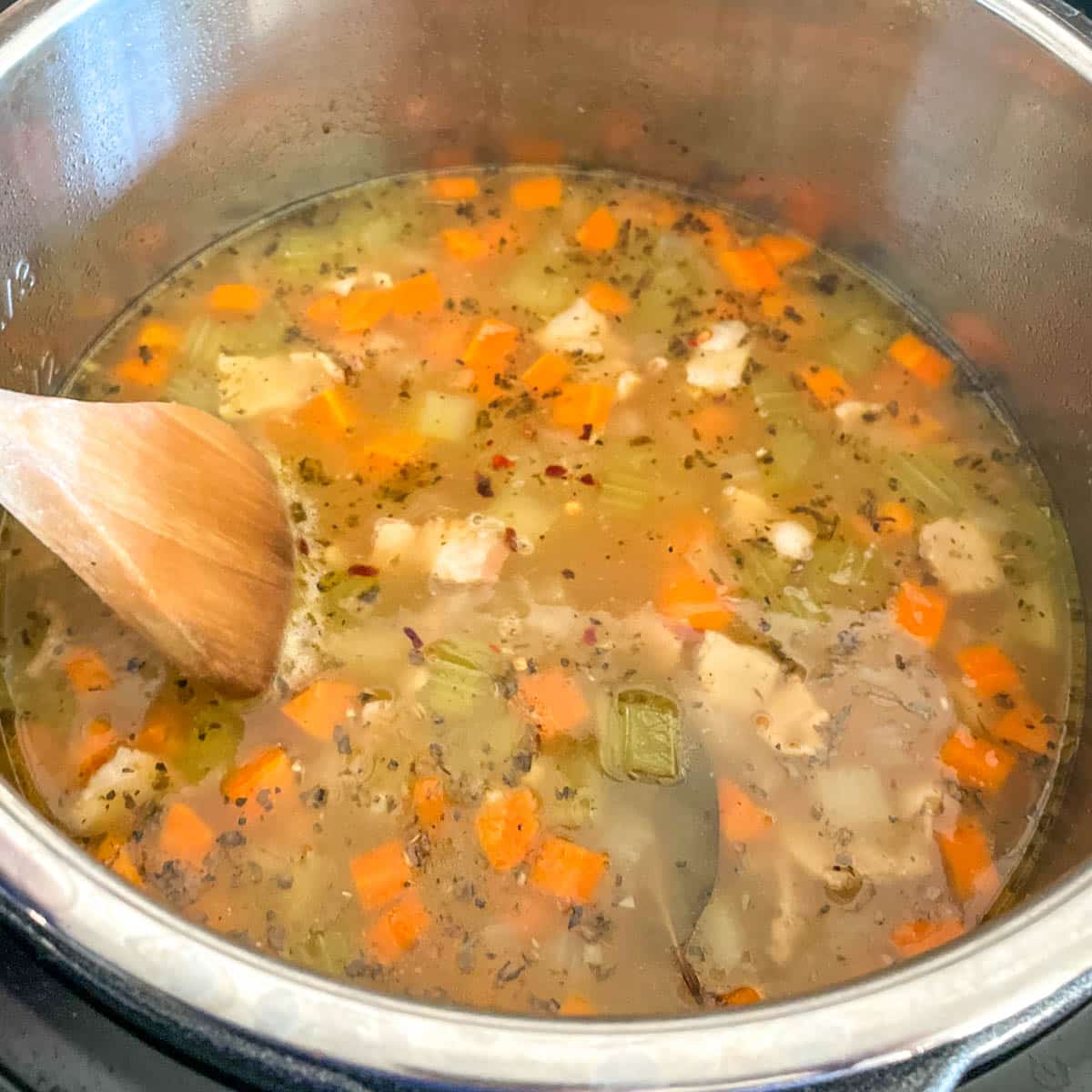 Beans and broth are added to the Instant Pot.