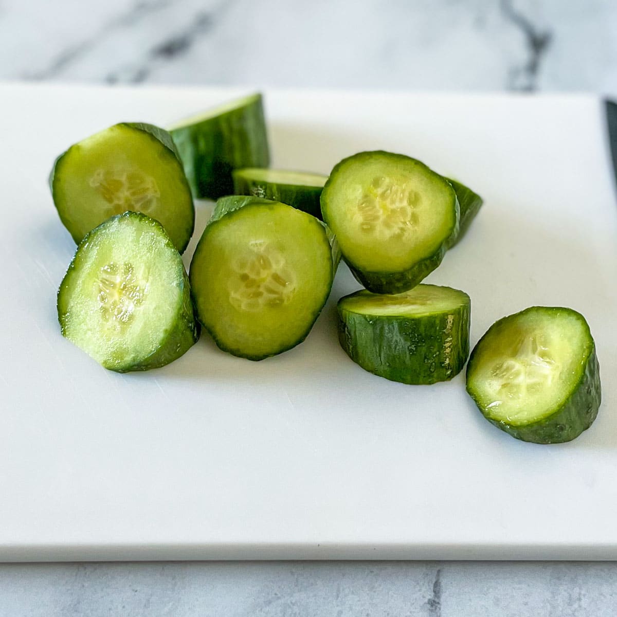 Cucumbers are shown cut into triangular wedges.