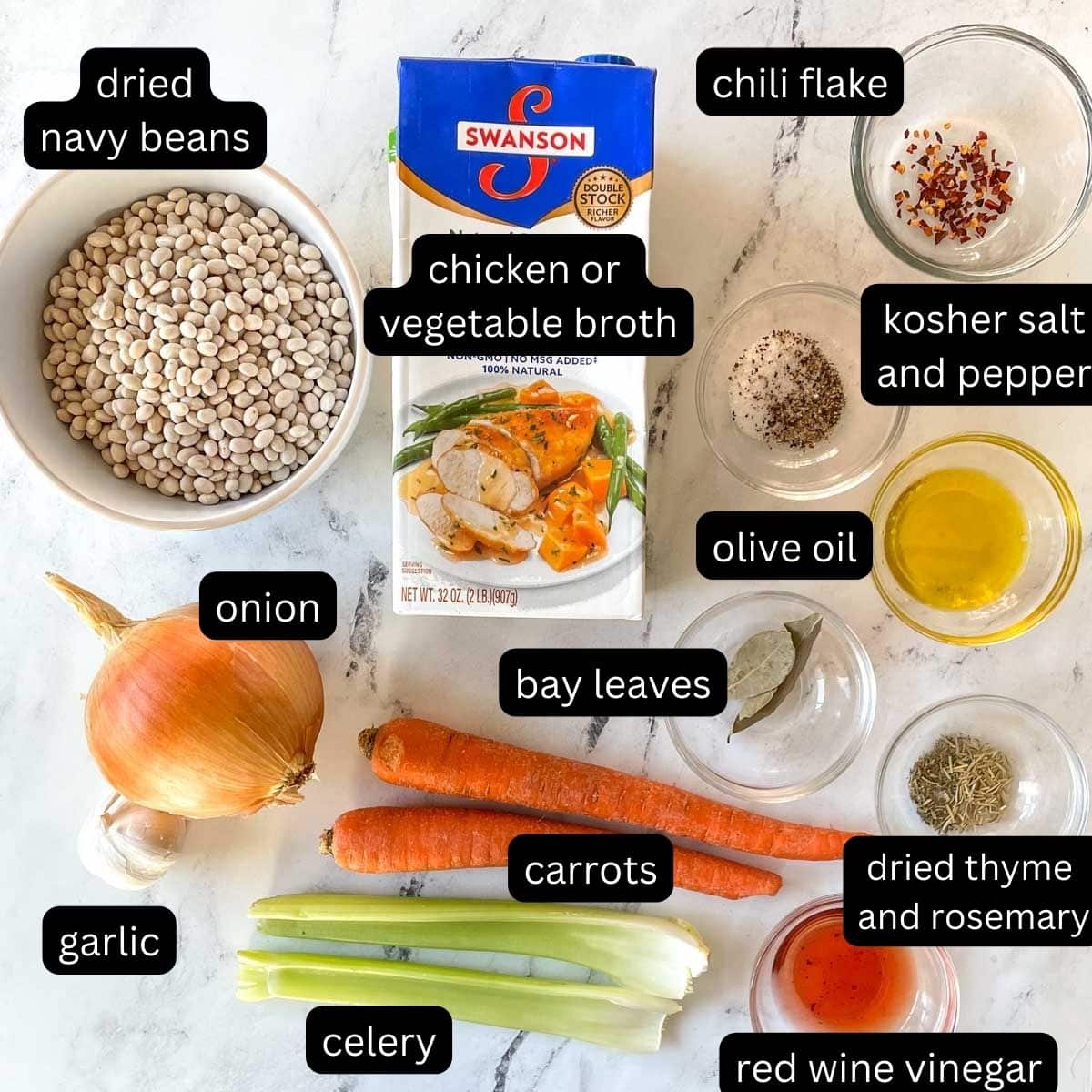 The labeled ingredients for Instant Pot Navy Bean Soup are shown on a white marble counter.