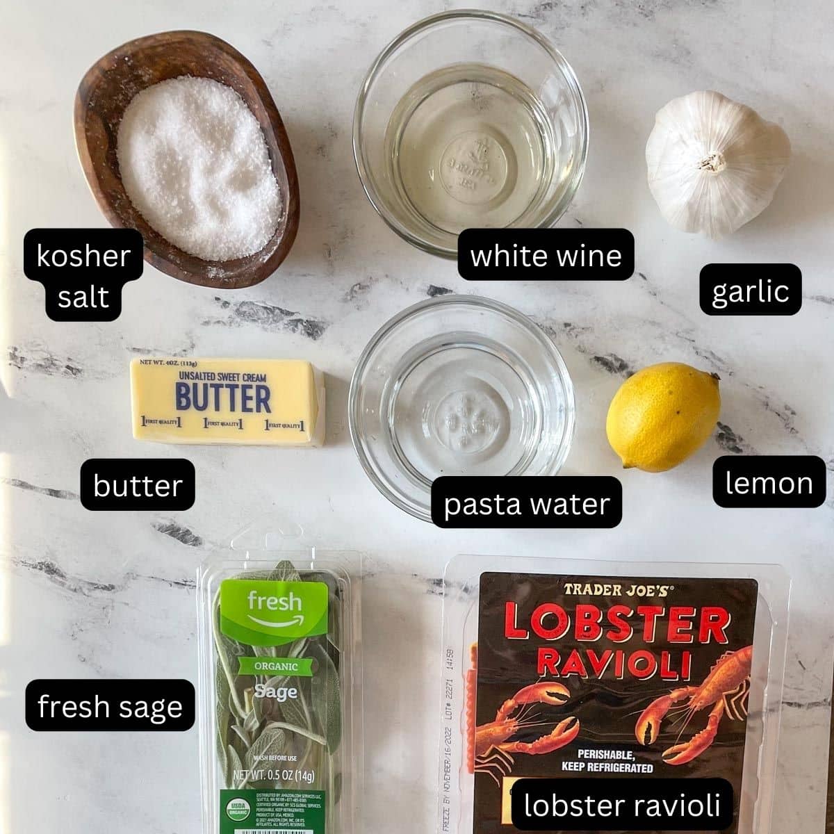 The labeled ingredients for lobster ravioli sauce are shown on a white marble counter.