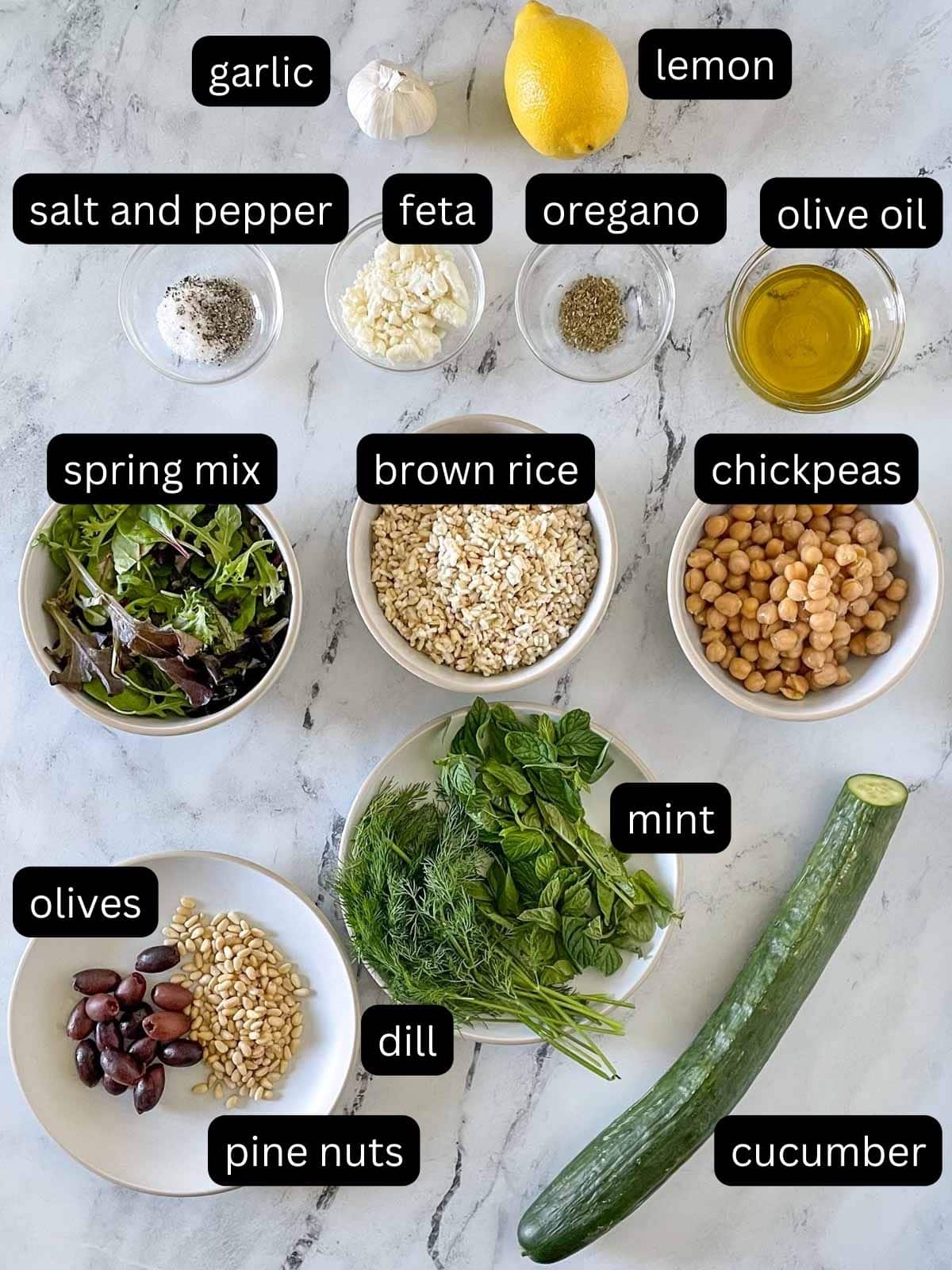 The labeled ingredients for Mediterranean Grain Bowls are shown on a white marble counter.