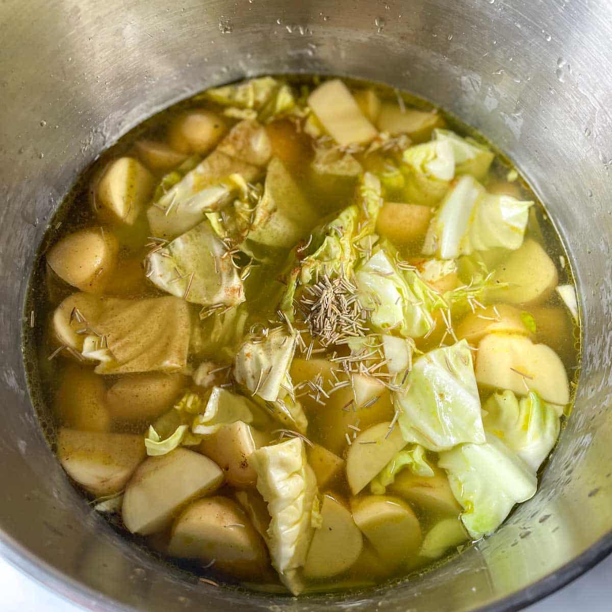 The broth and spices are added to the pot.