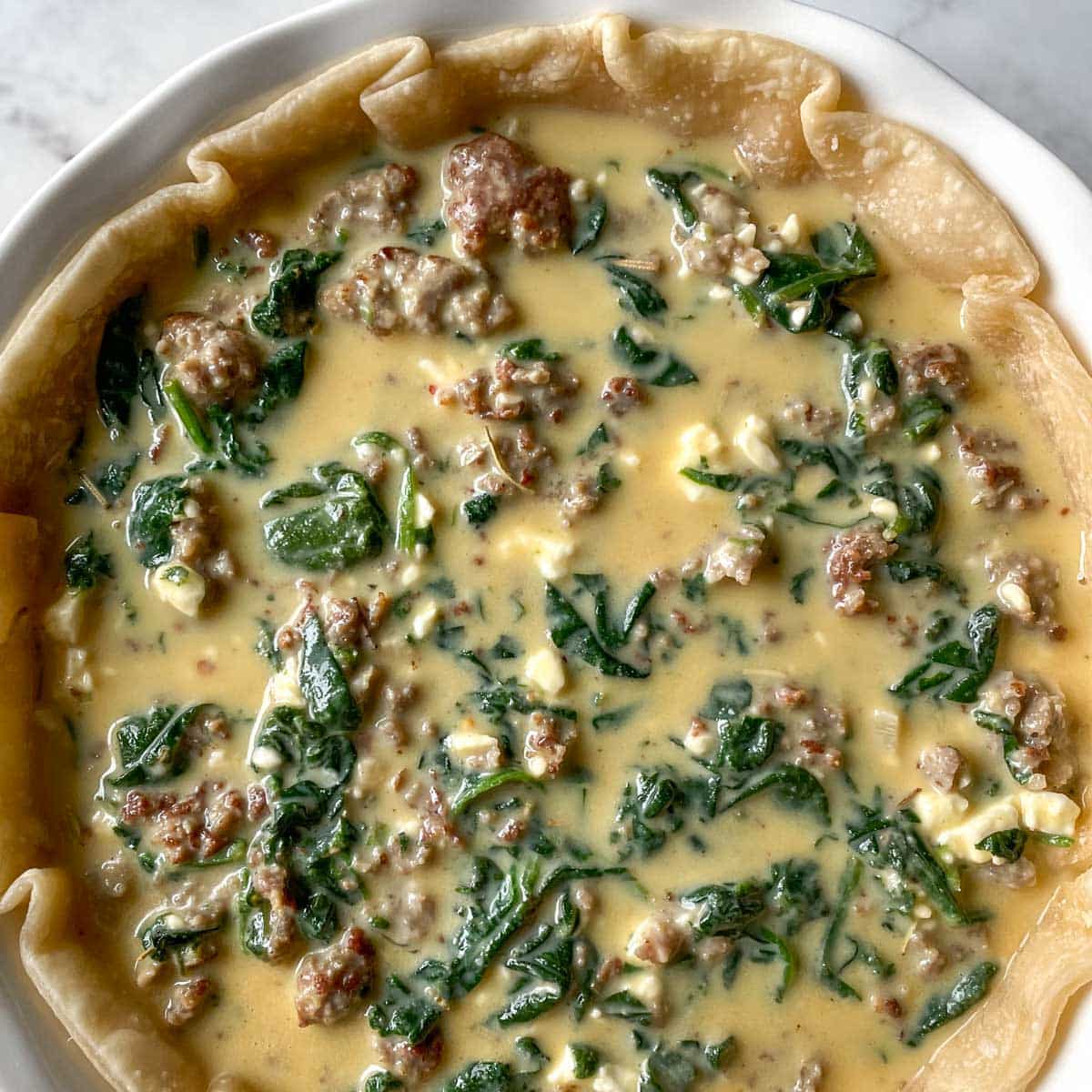 The filling is added to the quiche crust.