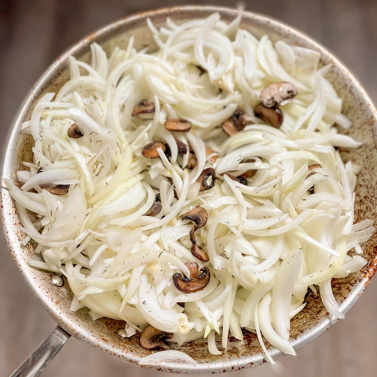 The onions and mushrooms are mixed together.
