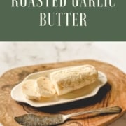 A log of butter is shown with the words Roasted Garlic Butter and the URL www.twocloveskitchen.com.