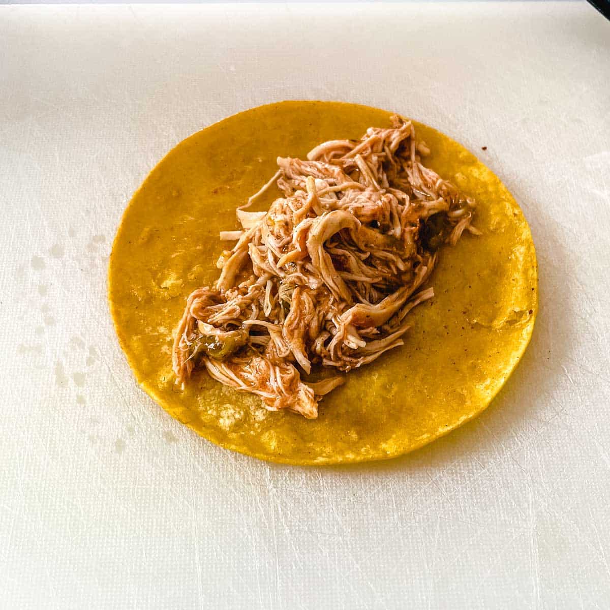 Chicken is added to the tortilla.