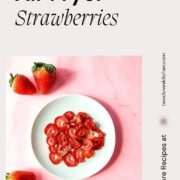 Dehydrated strawberries on a white plate with the text Air Fryer Strawberries and the URL www.twocloveskitchen.com.