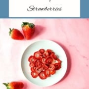 Dehydrated strawberries on a white plate with the text Air Fryer Strawberries and the URL www.twocloveskitchen.com.