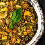 Farro with pesto and zucchini sits on a silver platter.