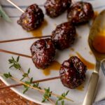Tiny sausage bites are skewered with toothpicks.