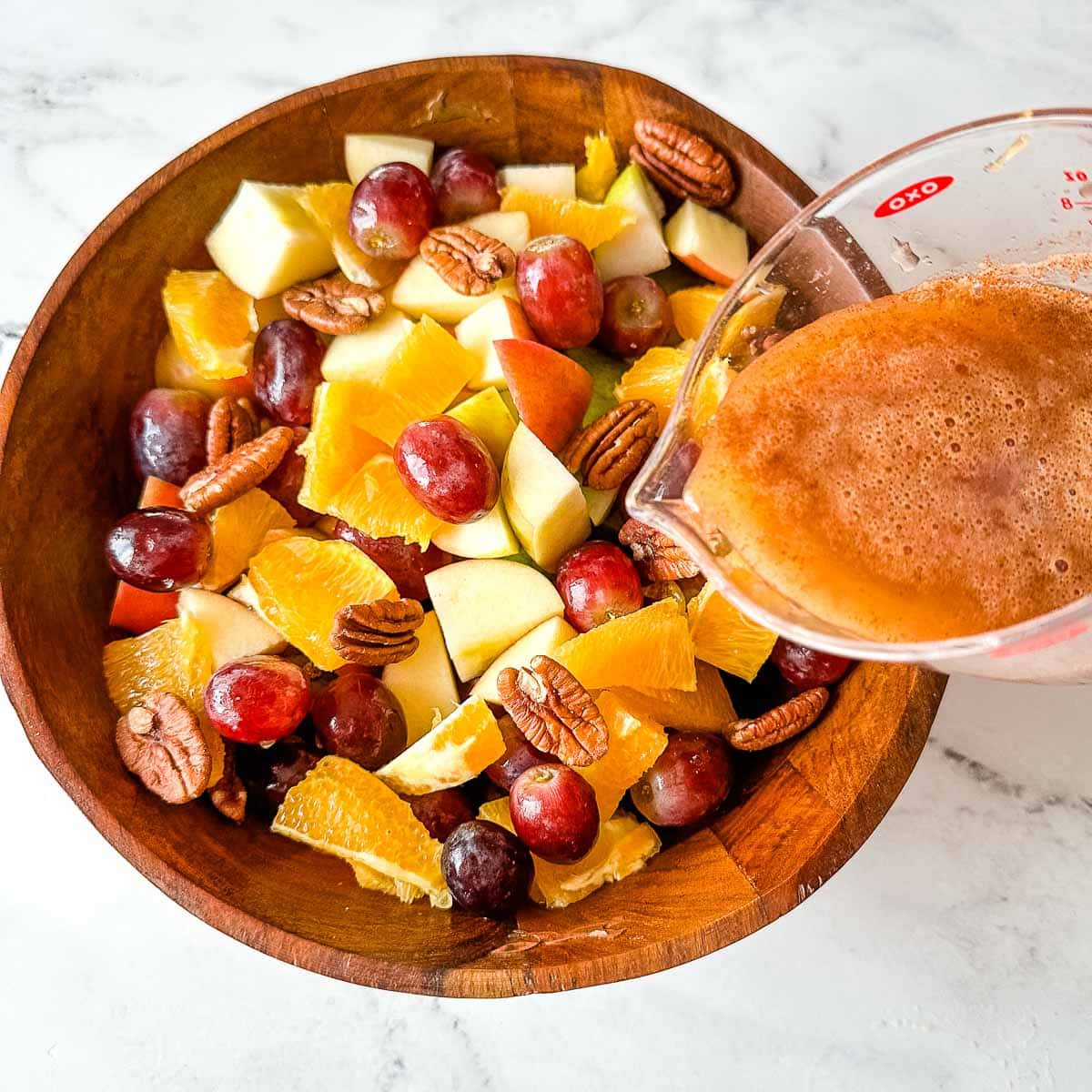 A Thanksgiving fruit salad it dressed with honey, apple pie spice, and orange juice.