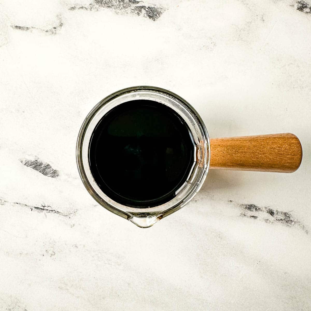 Balsamic Vinegar in Small Pitcher with wooden handle.