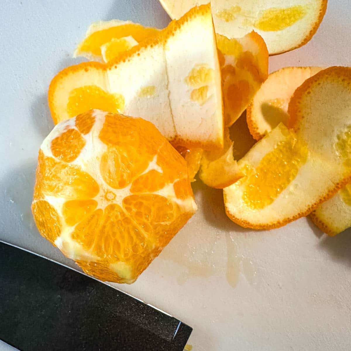 The peel is cut away from an orange.