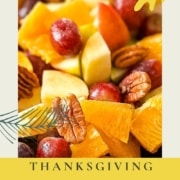 Closeup of fruit salad with the words Thanksgiving Fruit Salad and the URL www.twocloveskitchen.com.