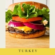 A turkey smash burger on a wooden cutting board with the words Turkey Smash Burgers and the URL www.twocloveskitchen.com.