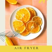 Air fryer dehydrated orange slices on a white plate with the words Air Fryer Orange Slices and the URL www.twocloveskitchen.com.