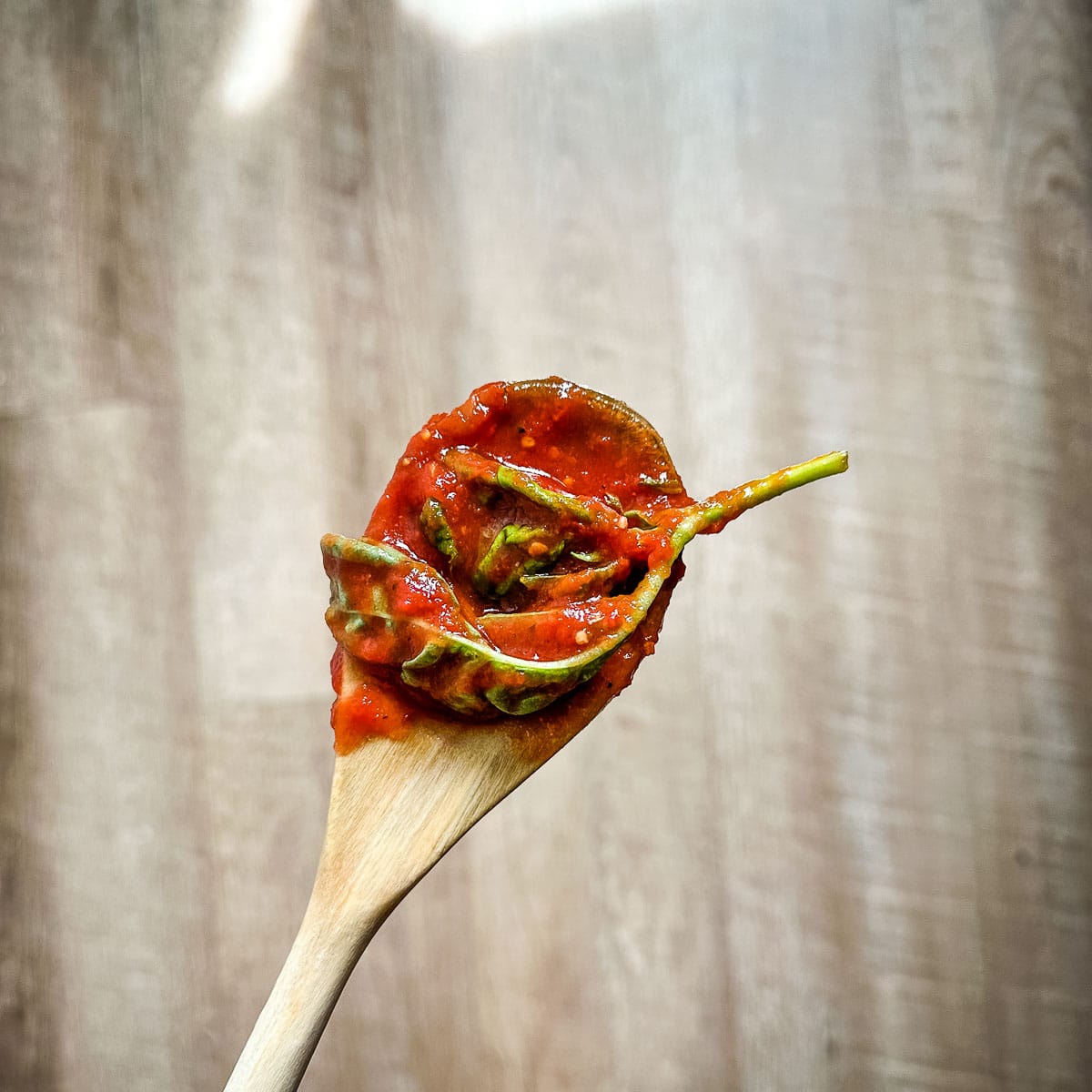 Basi leaves are removed from the marinara sauce.