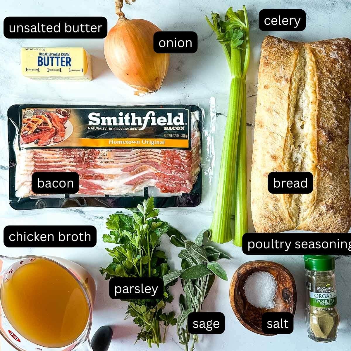 The labeled ingredients for bacon and sage stuffing sit on a white marble counter.