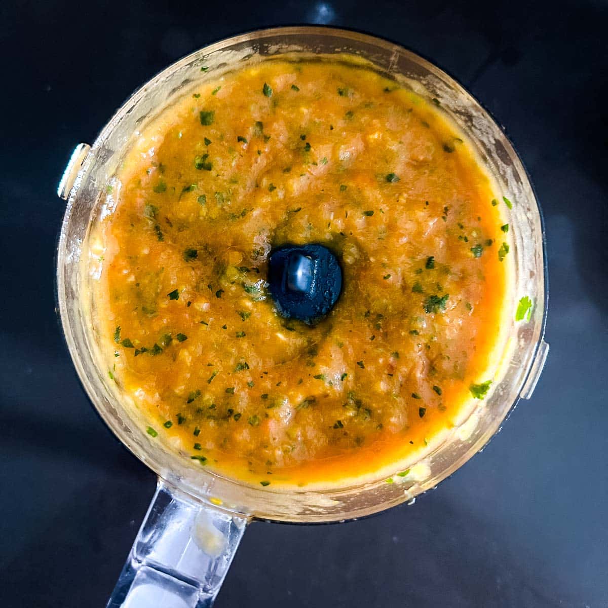 Blended mango habanero salsa in a mini food processor.