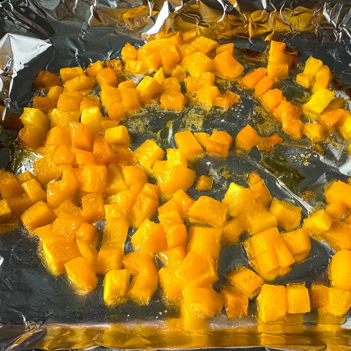 Roasted diced mango on a sheet tray.