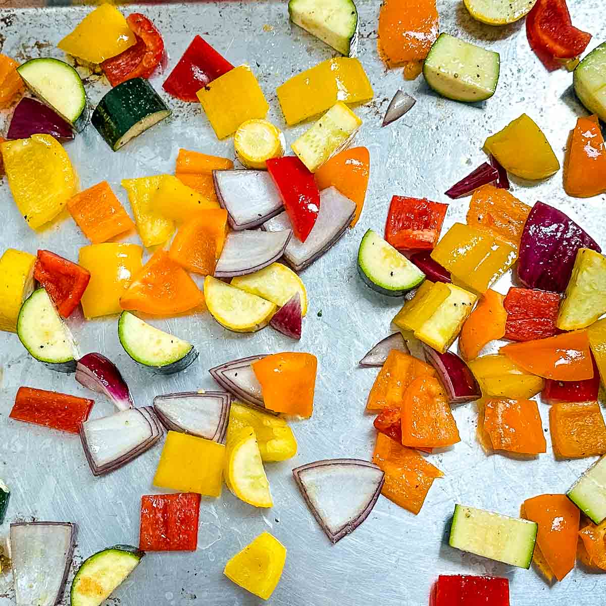 cut vegetables on a sheet tray.