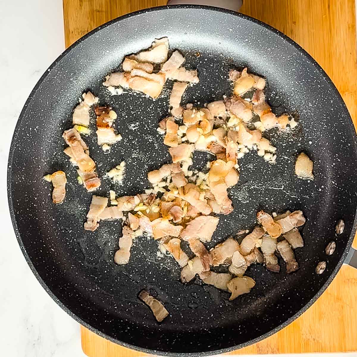 bacon and garlic in frying pan.