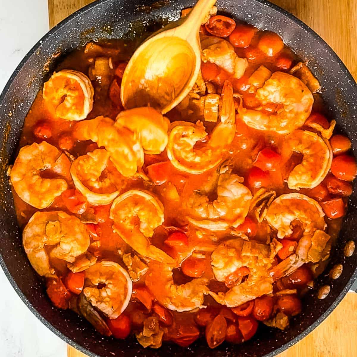shrimp cooking in bloody mary sauce.