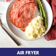 ham steak with asparagus and mashed potatoes with the words air fryer ham steak and the URL two cloves kitchen dot com.