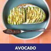 avocado tartine on a blue plate with the words avocado tartine and the URL for two cloves kitchen dot com.