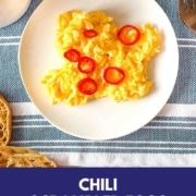 scrambled eggs topped with sliced chili pepper with the words Chili scrambled eggs and the URL two cloves kitchen dot com.