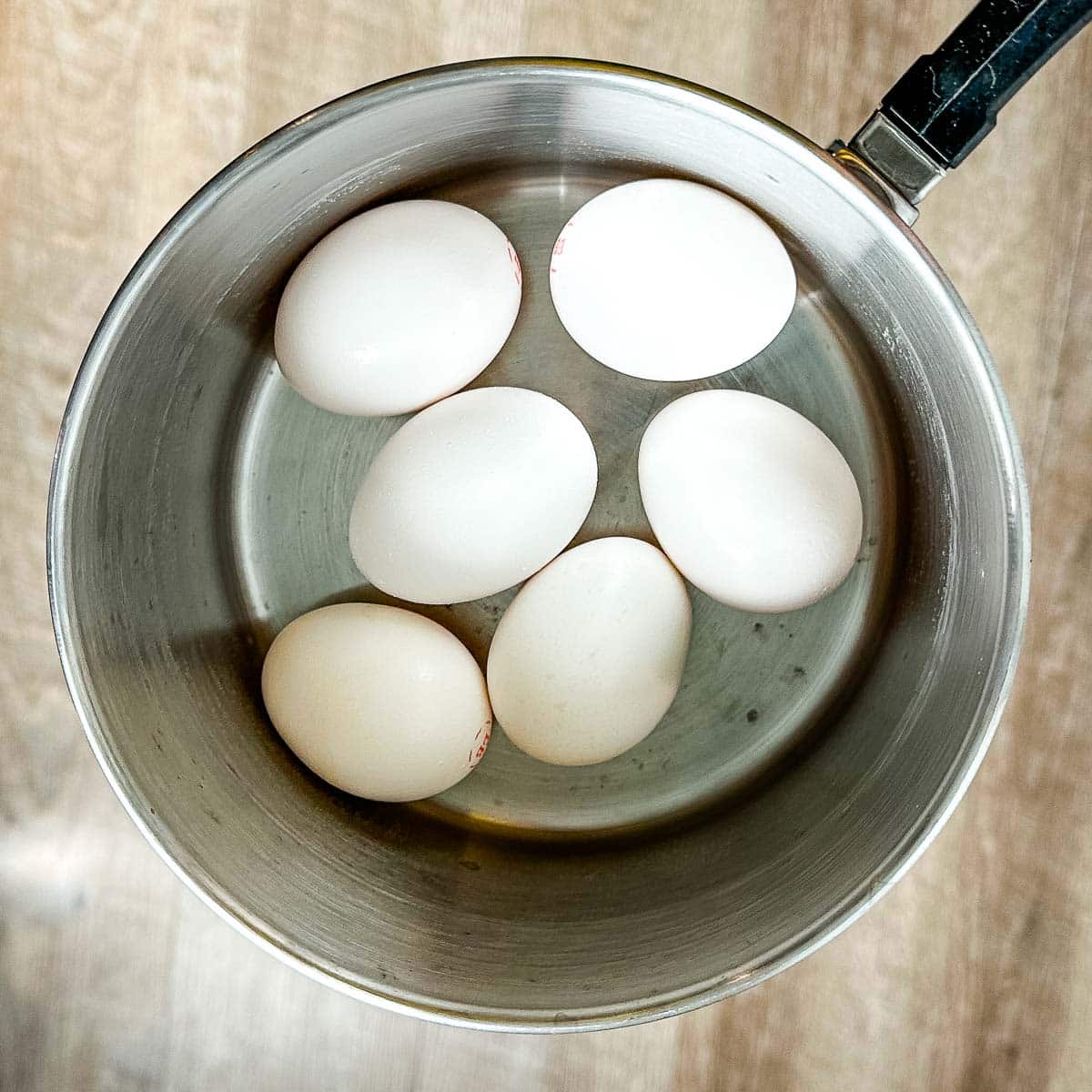 eggs in a stainless steel pot.