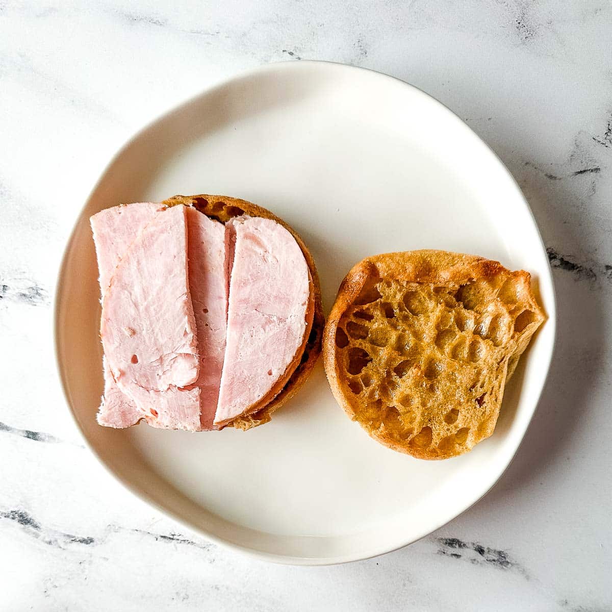 turkey slices on a toasted English muffin.