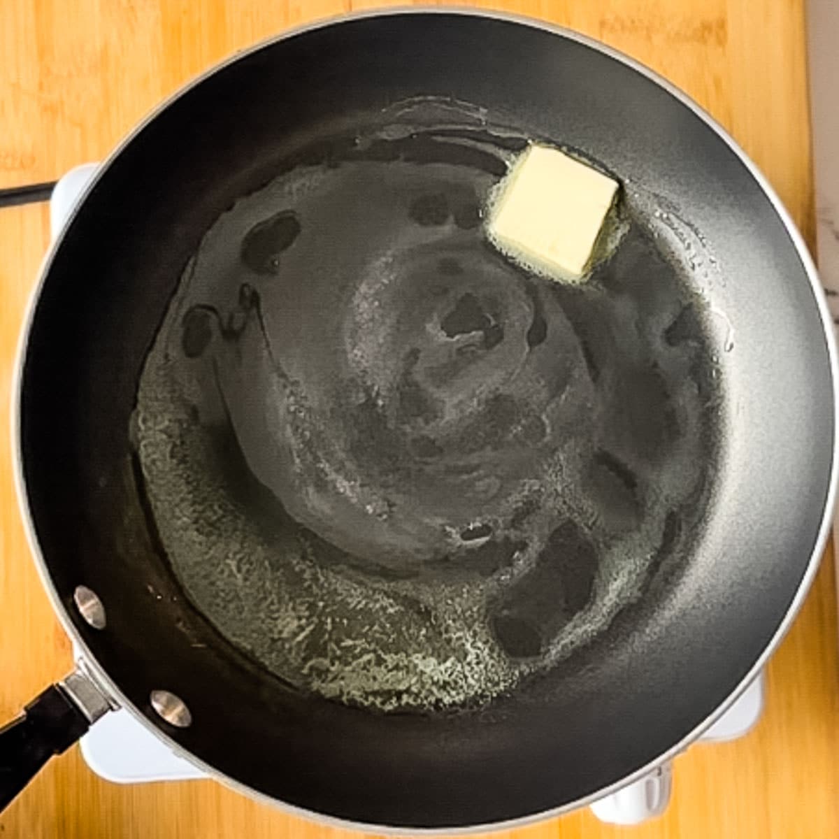 butter melted in frying pan.