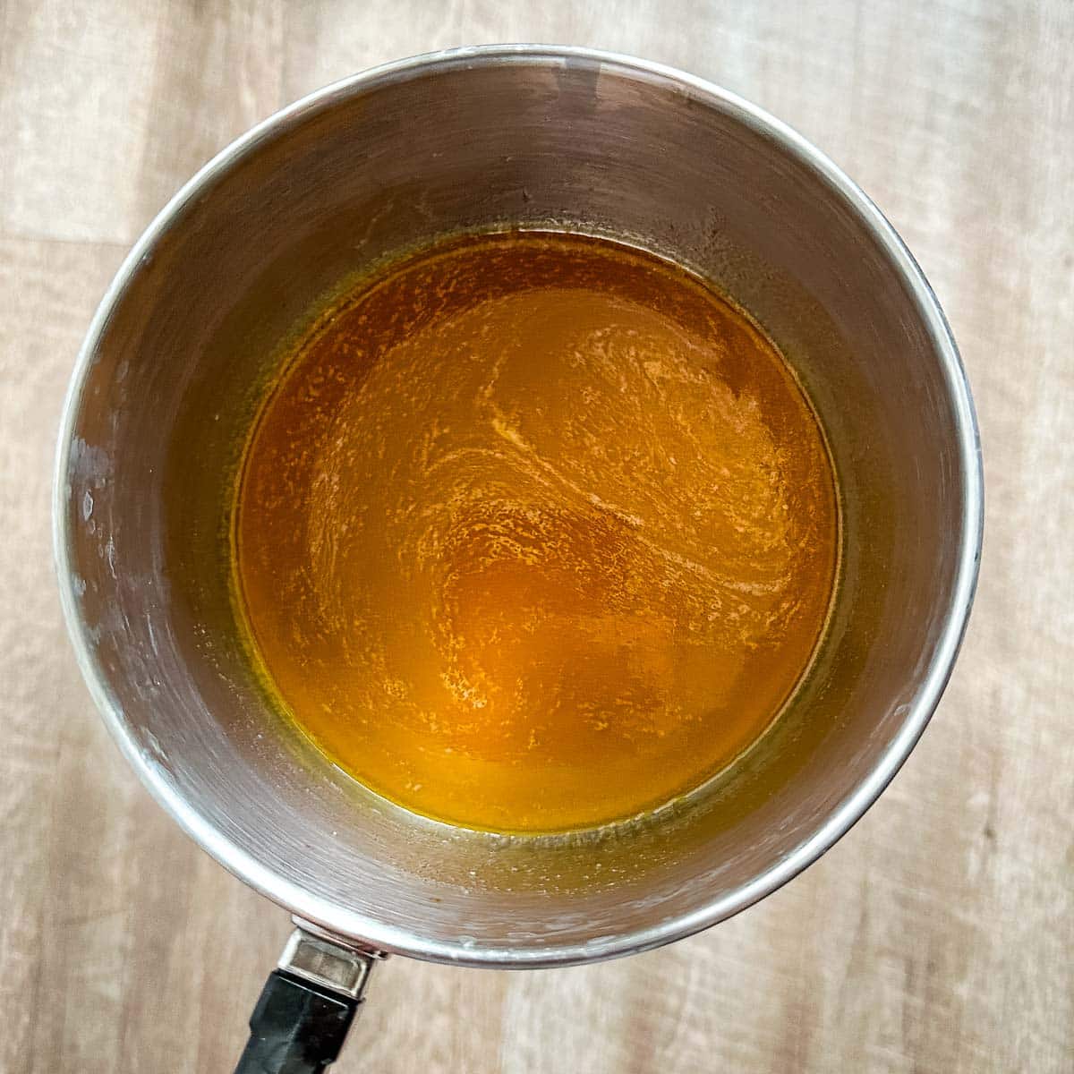 Honey, hot sauce, and butter simmering in a saucepot.
