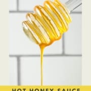 Closeup of honey dipper dripping honey with the words hot honey sauce and the URL two cloves kitchen dot com.