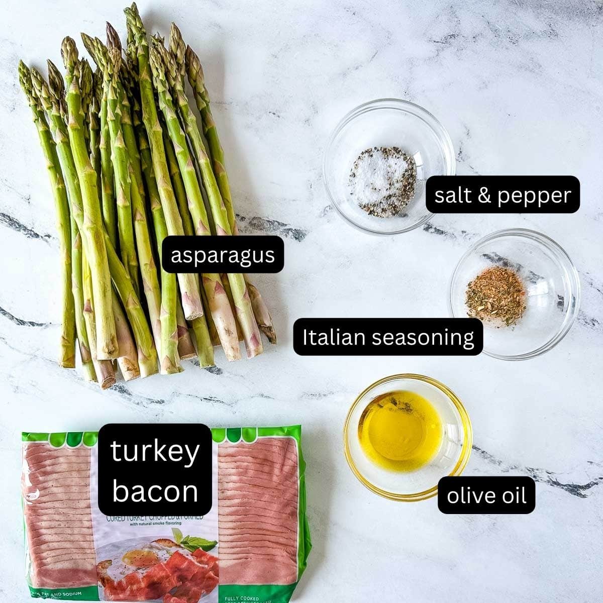 labeled ingredients for turkey bacon wrapped asparagus on a white marble counter.