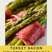 brushing turkey bacon wrapped asparagus bundles with the words turkey bacon wrapped asparagus and the URL two cloves kitchen dot com.