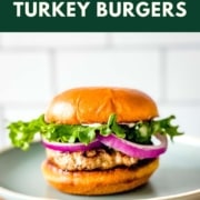 A turkey burger on a light blue plate with the words air fryer turkey burger and the web address two cloves kitchen dot com.