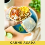 An image with a breakfast burrito is held over a blue plate and including the words carne asada breakfast burrito and the web address two cloves kitchen dot com.
